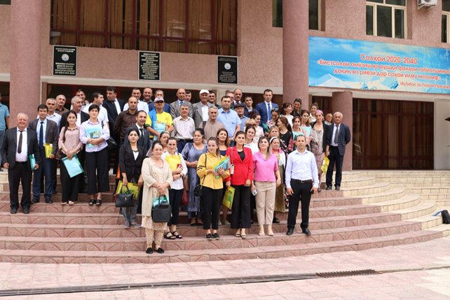 The participants and the presenters of the GBAO workshop are standing on the stairs in front of a building.