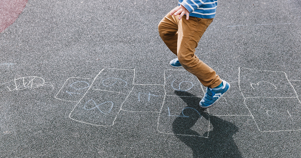 child playing hopscotch